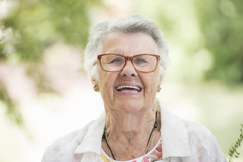 An older woman with a big smile on her face 