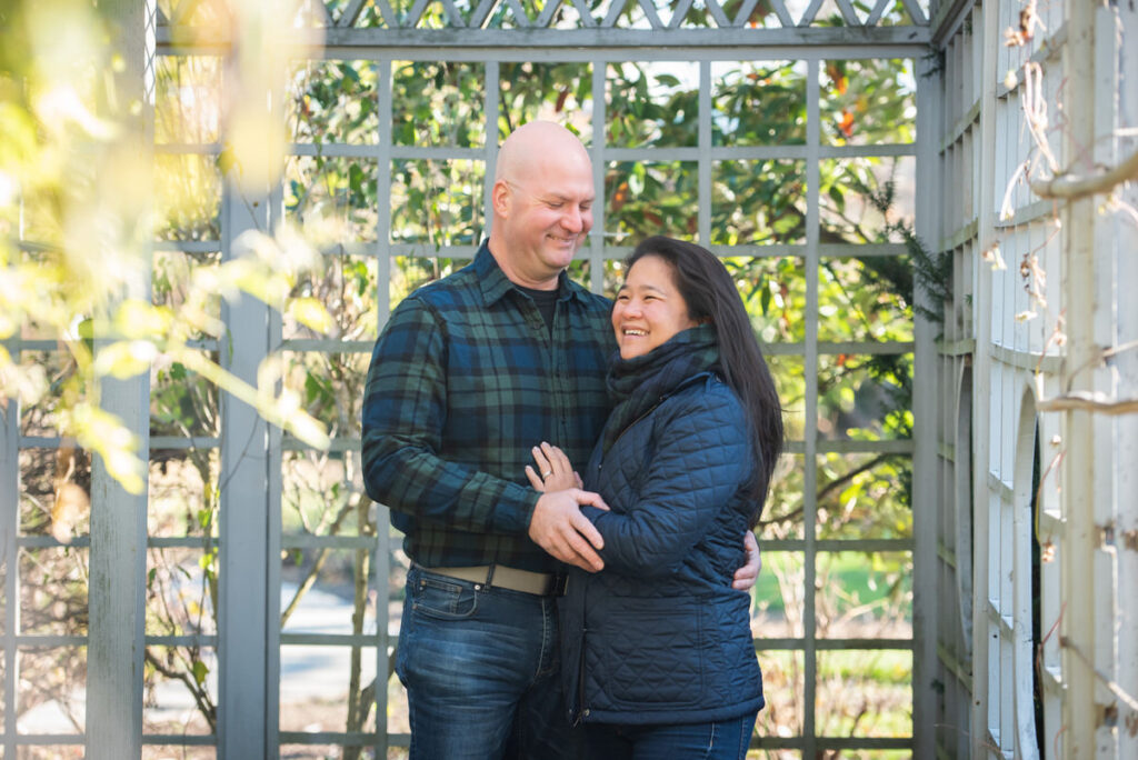 Two people smiling with their arms around each other 