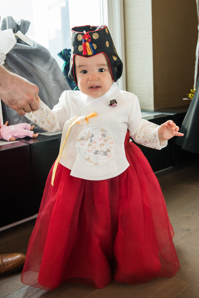 A small child in a traditional Asian outfit 